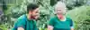 Two People Laughing Together In A Garden Setting